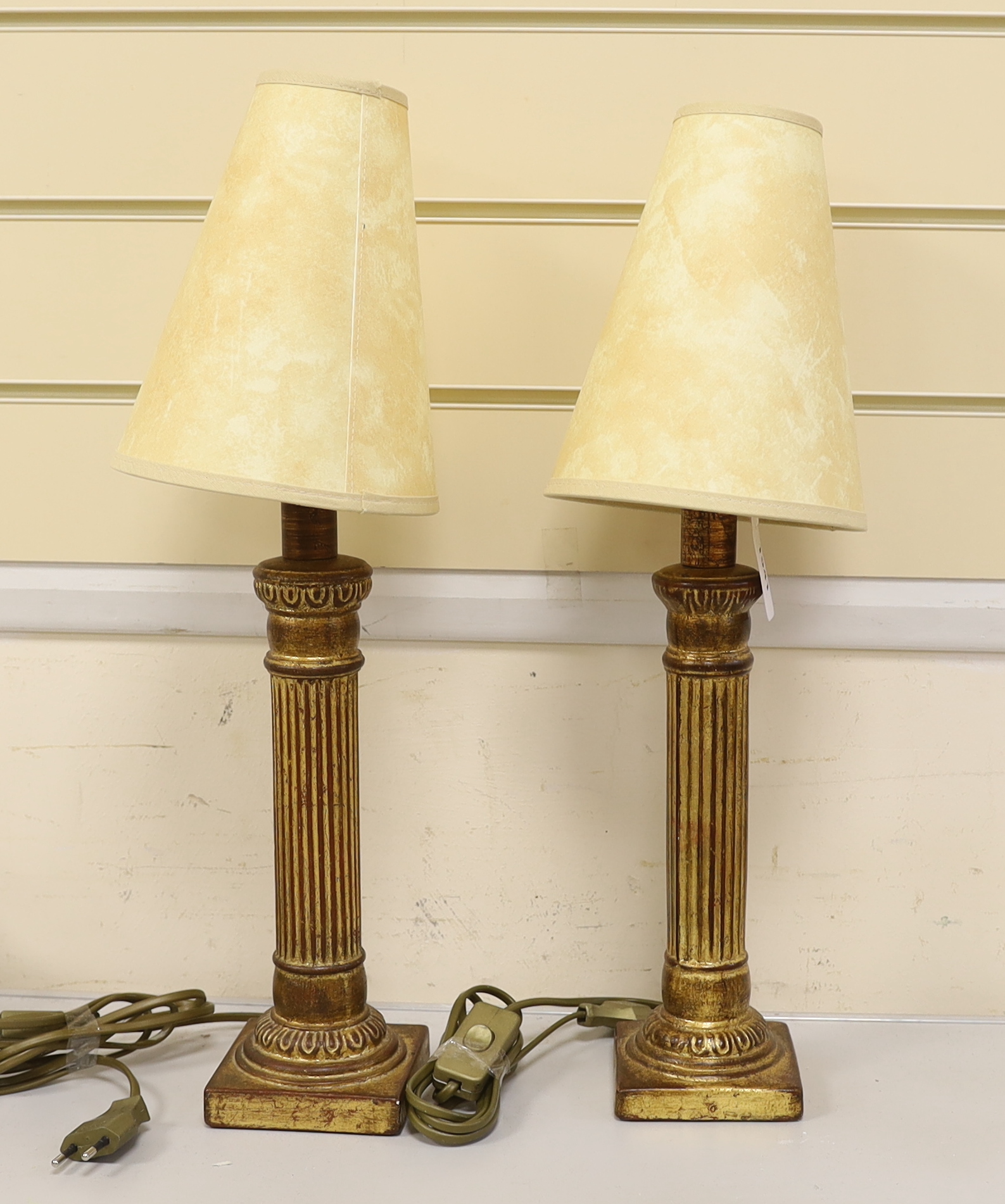 A pair of 20th century Swedish partially gilt table lamps with shades